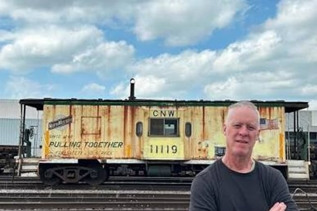 Author Joseph G. Peterson in front of a train car