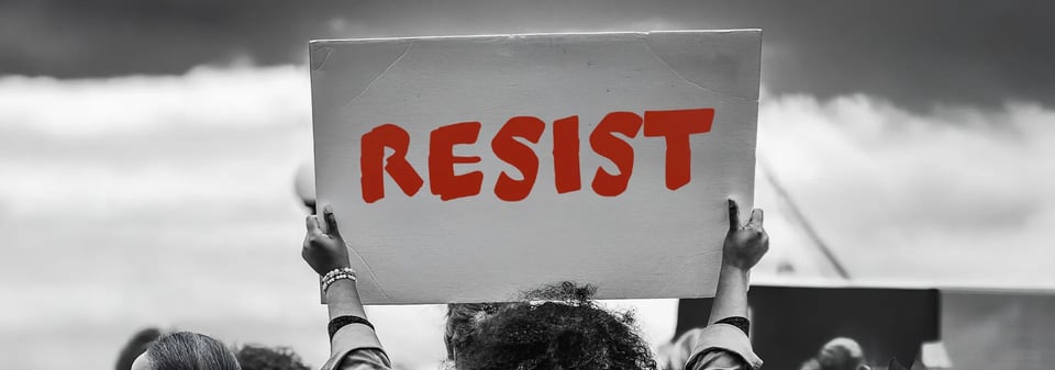 photo of person holding up a resist sign