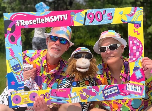 two people and a puppet in loud clothing