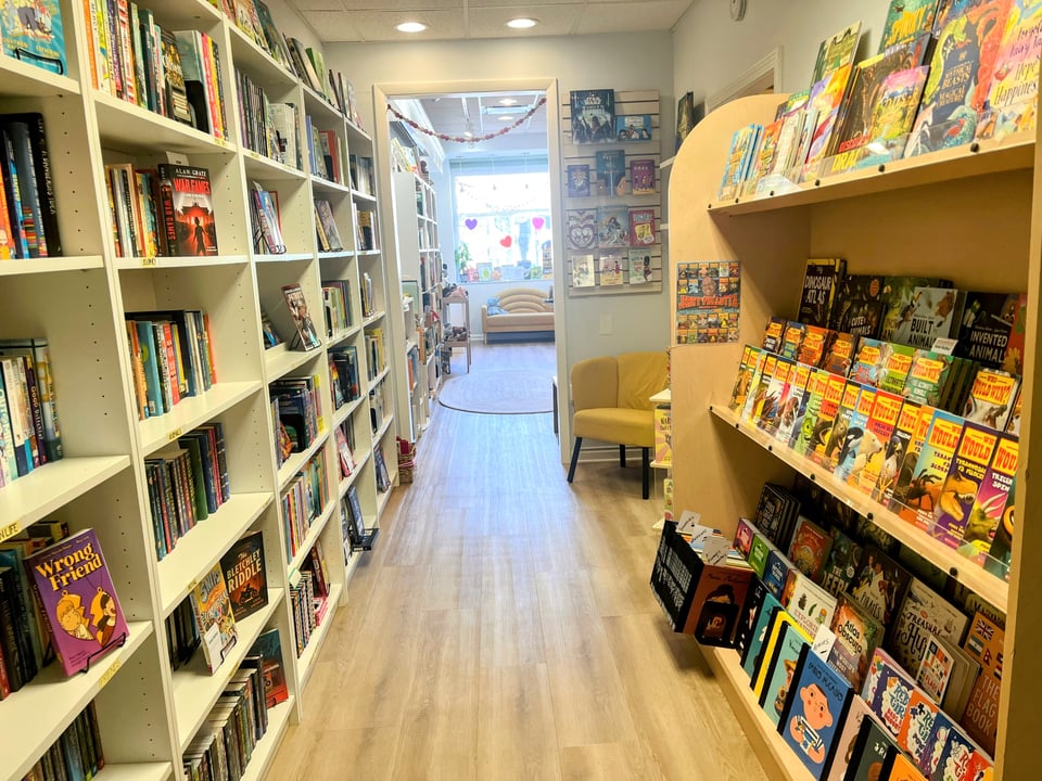 bookshelves of bigger kid room and cozy seats