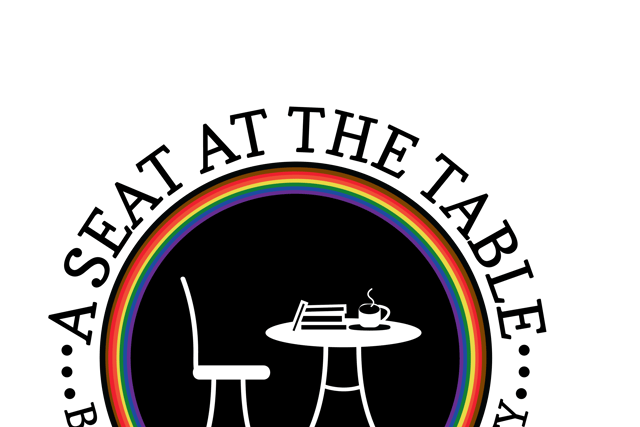 Black circle surrounded by thin bands of rainbow colored circles, containing a seat, table, books, and coffee, surrounded by our name