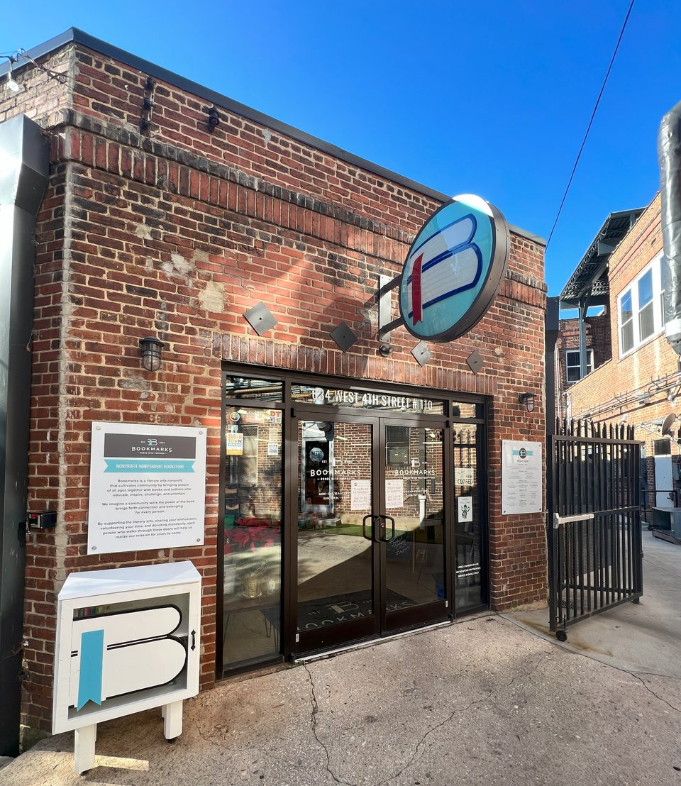 A historic brick building with a large marquee sign featuring the Bookmarks logo